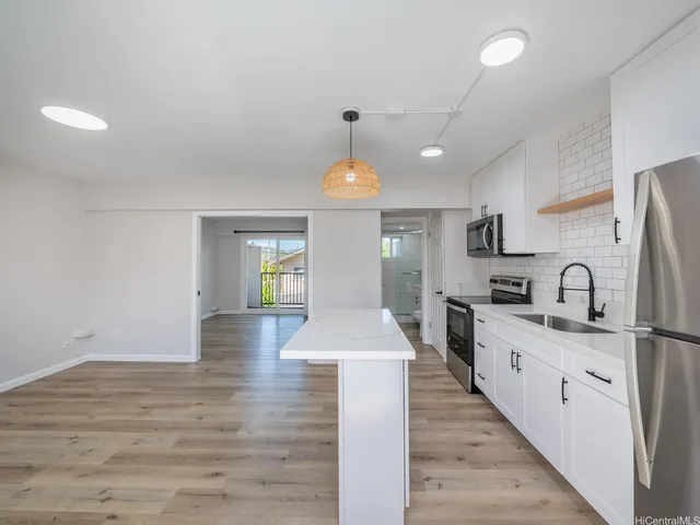 a kitchen with a refrigerator a sink and a stove