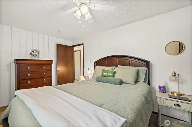 a bedroom with a bed and a dresser