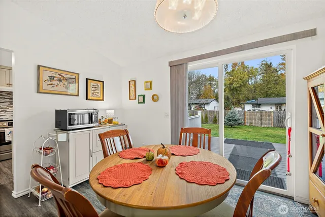 a view of a dining room with furniture large window and wooden floor