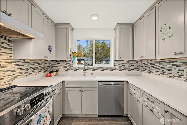 a kitchen with a sink stove and cabinets
