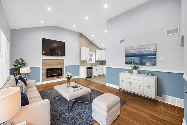 a living room with furniture a fireplace and a flat screen tv