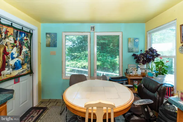 a view of a dining room with furniture a rug and wooden floor