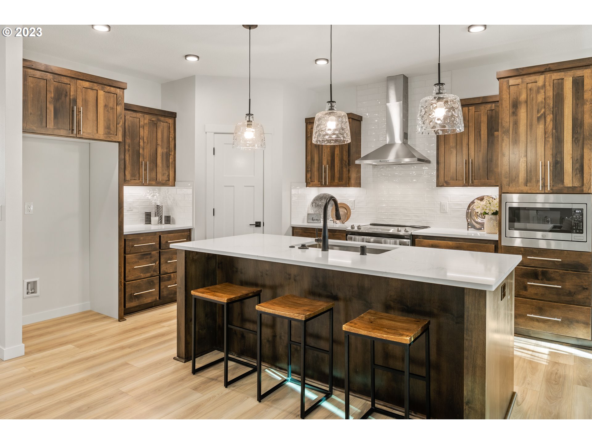 4011 South Hay Field Circle Ridgefield, WA 98642 - Photo 8 of 32 a kitchen with cabinets and chairs