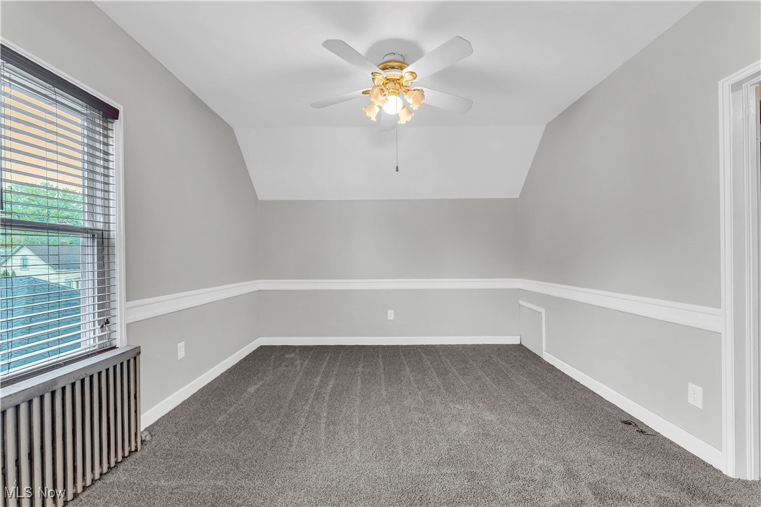 3374 Fulton Road Cleveland, OH 44109 - Photo 20 of 27 Additional living space featuring radiator, carpet flooring, lofted ceiling, and a ceiling fan