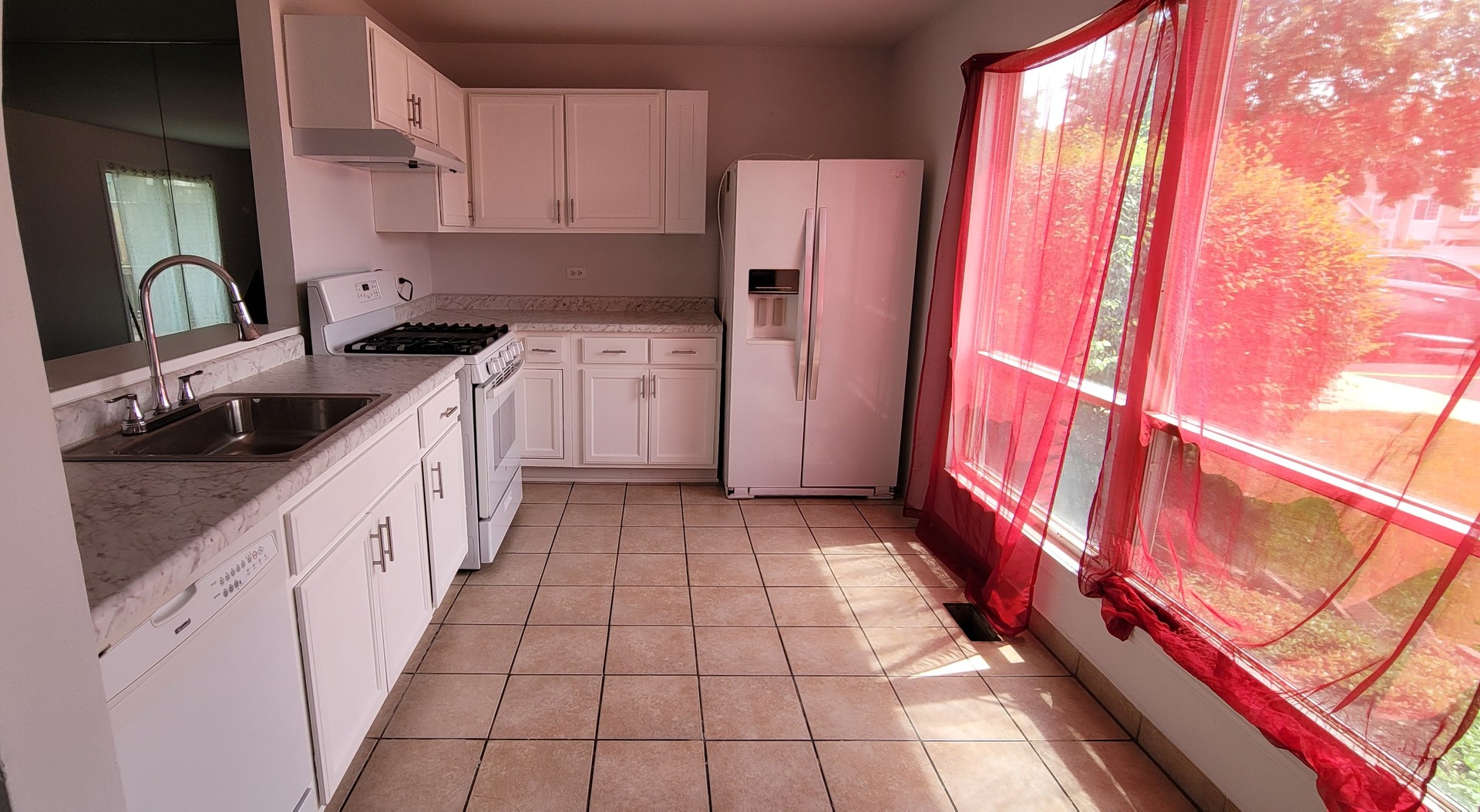249 Peppertree Lane Aurora, IL 60504 - Photo 9 of 10 a kitchen with a sink a refrigerator and cabinets