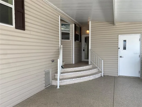 a view of wooden door and a refrigerator