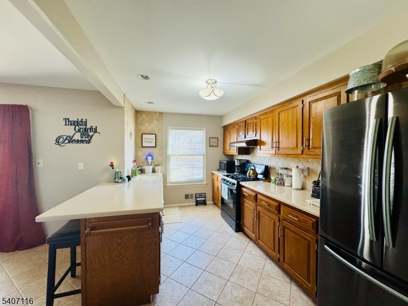 174 Carson Court Somerset, NJ 08873 - Photo 5 of 21 a kitchen with stainless steel appliances a refrigerator sink and stove