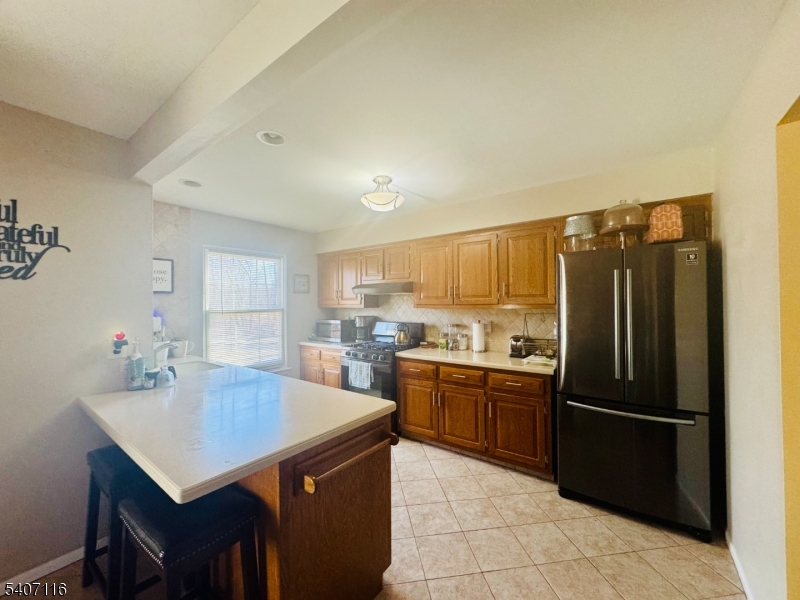 174 Carson Court Somerset, NJ 08873 - Photo 6 of 21 a kitchen with stainless steel appliances granite countertop a refrigerator a sink a stove and island