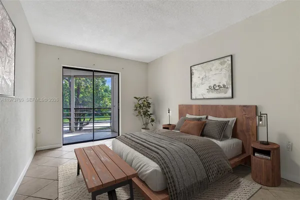 a bedroom with a large bed and a window