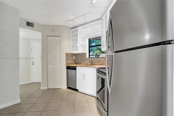 a kitchen with a refrigerator and a sink