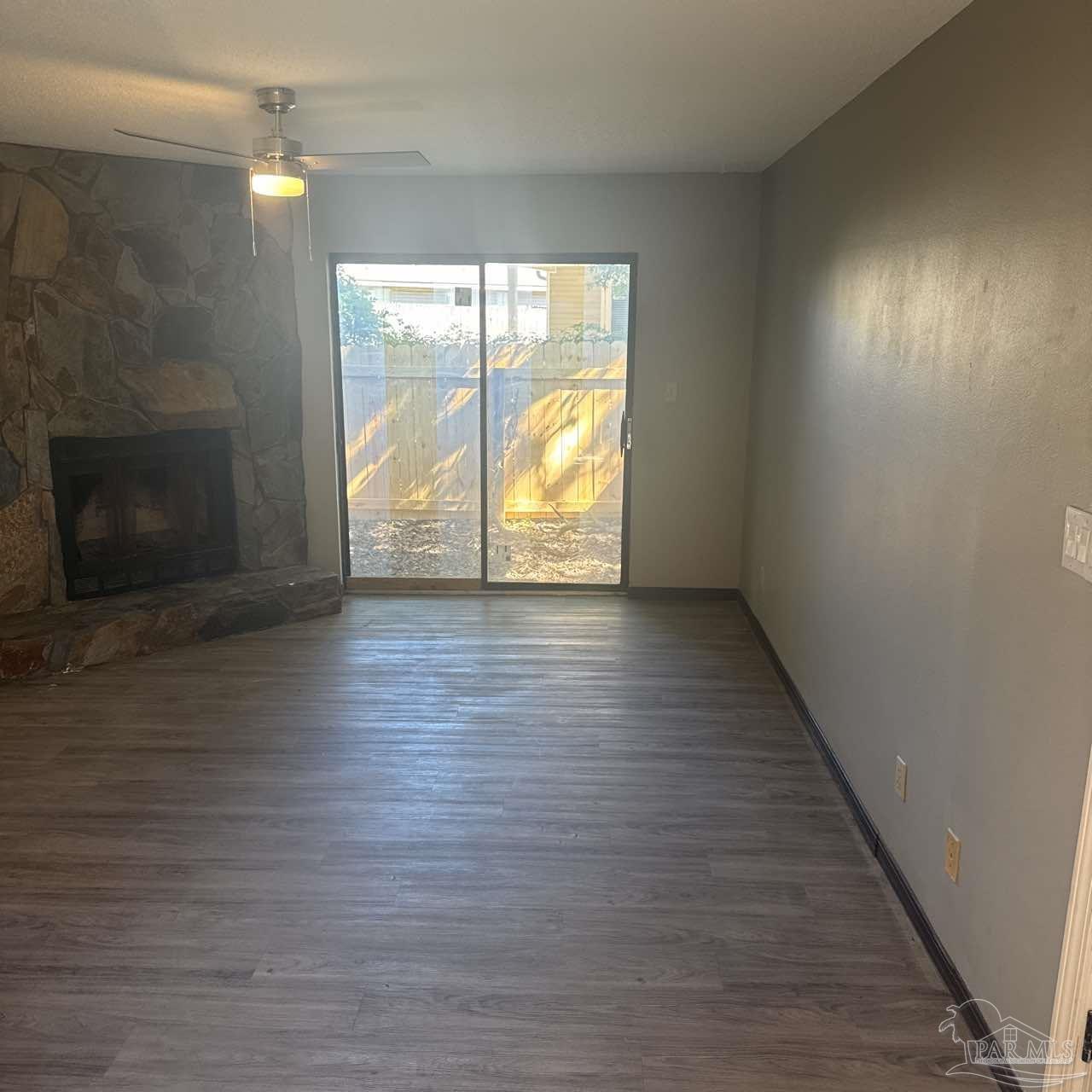 455 Stara Circle, Unit C Pensacola, FL 32505 - Photo 1 of 23 an empty room with wooden floor and windows