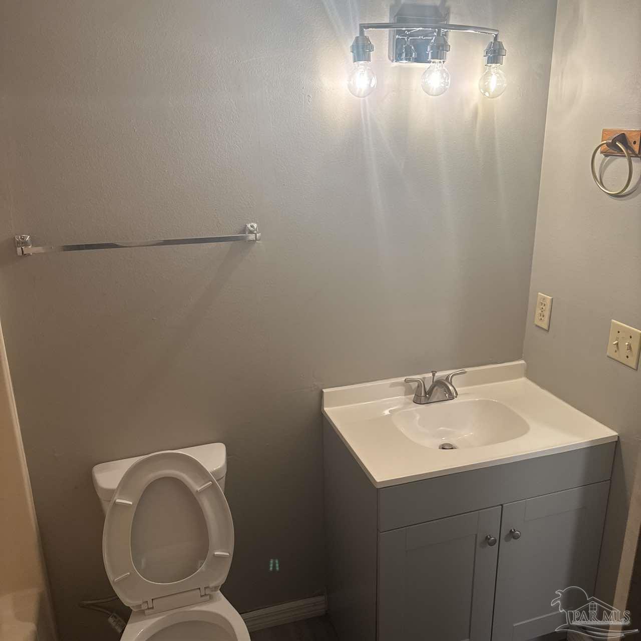 455 Stara Circle, Unit C Pensacola, FL 32505 - Photo 16 of 23 a bathroom with a toilet sink and mirror