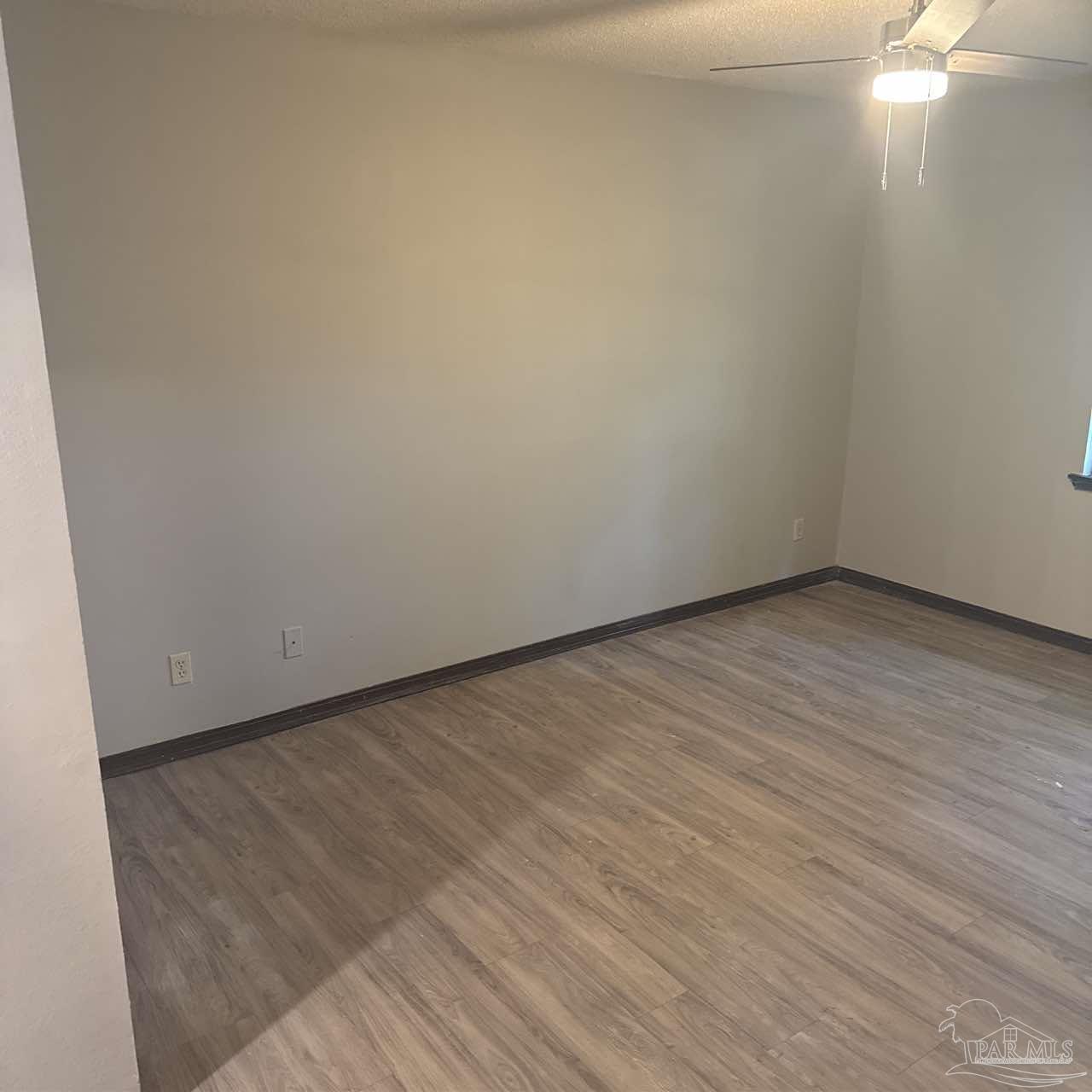 455 Stara Circle, Unit C Pensacola, FL 32505 - Photo 18 of 23 a view of an empty room with wooden floor