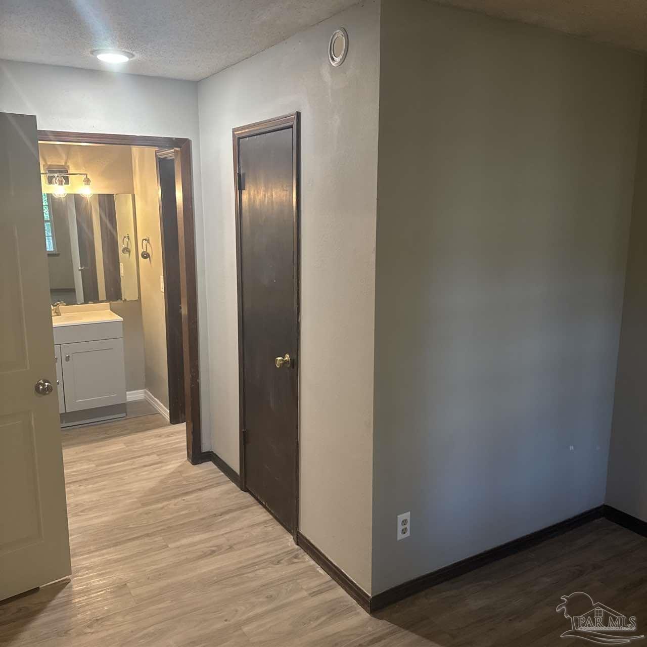 455 Stara Circle, Unit C Pensacola, FL 32505 - Photo 19 of 23 a view of an empty room with wooden floor and a bathroom