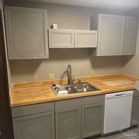 a kitchen with a sink and cabinets