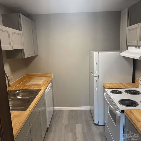 a kitchen with a stove and a refrigerator