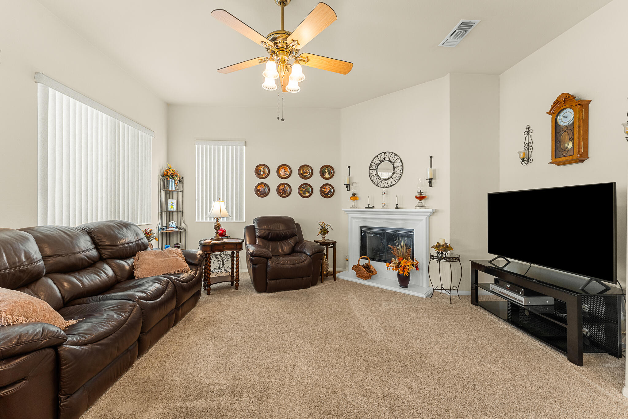 744 Copper Circle Beaumont, CA 92223 - Photo 13 of 44 a living room with furniture a flat screen tv and a fireplace