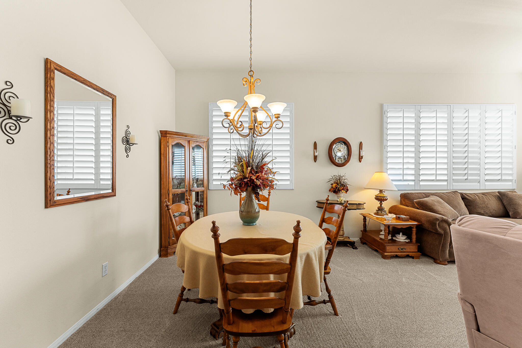 744 Copper Circle Beaumont, CA 92223 - Photo 16 of 44 a living room with furniture a chandelier and a window
