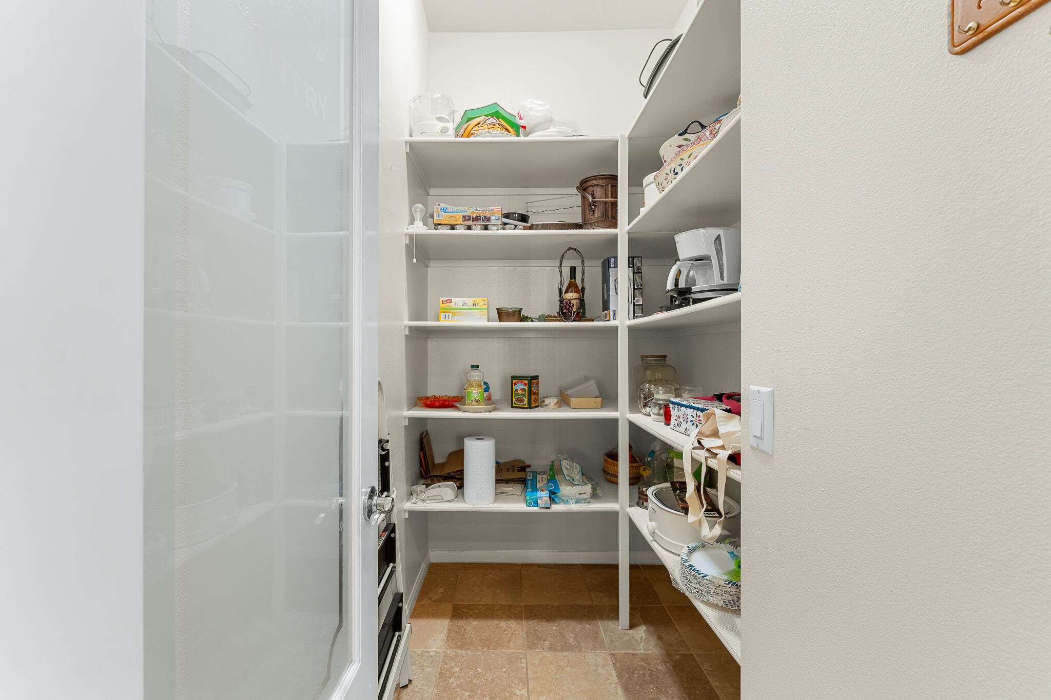 744 Copper Circle Beaumont, CA 92223 - Photo 19 of 44 a view of storage and utility room with racks on the wall