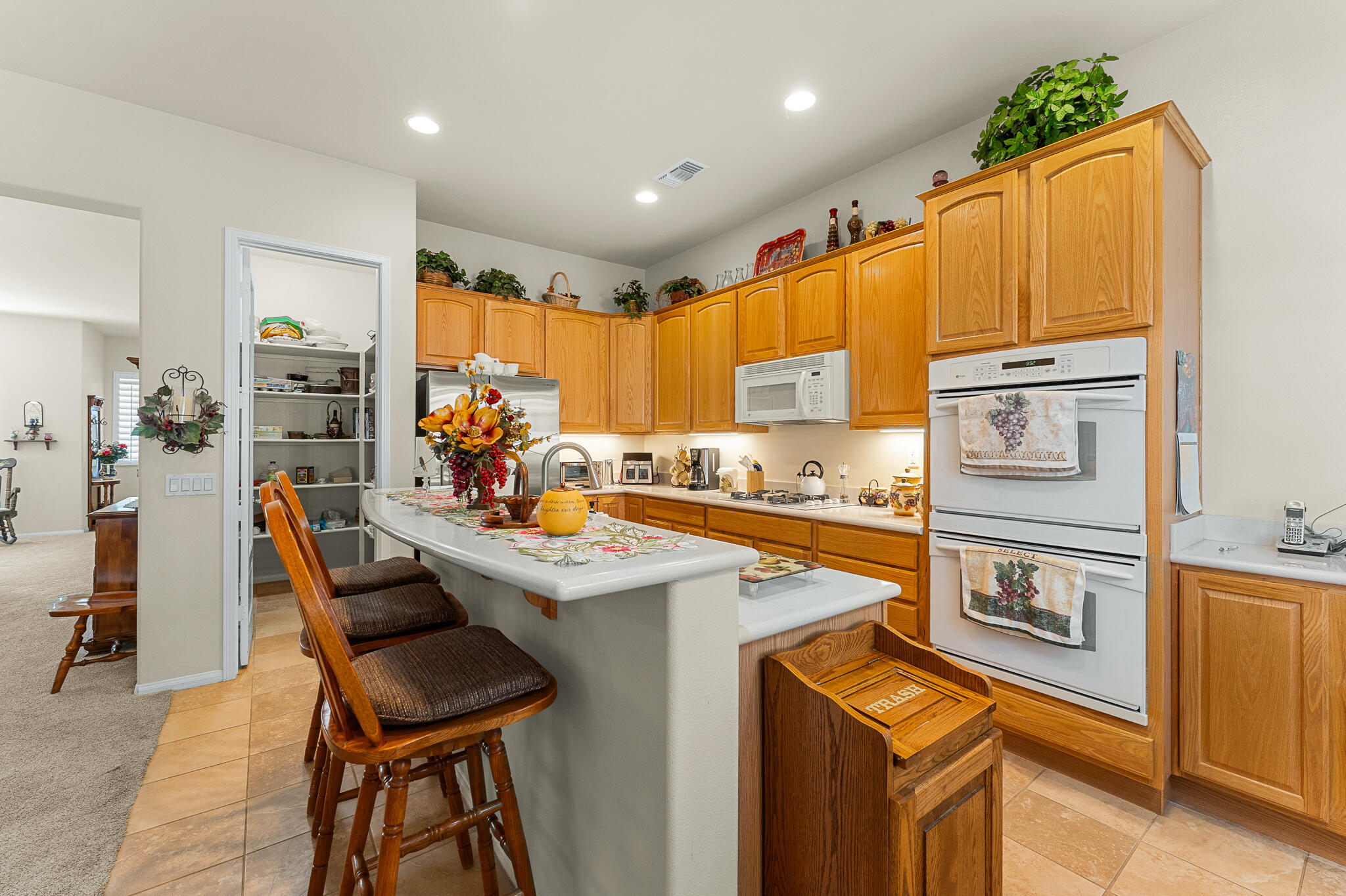 744 Copper Circle Beaumont, CA 92223 - Photo 20 of 44 a kitchen that has a lot of cabinets in it and stainless steel appliances