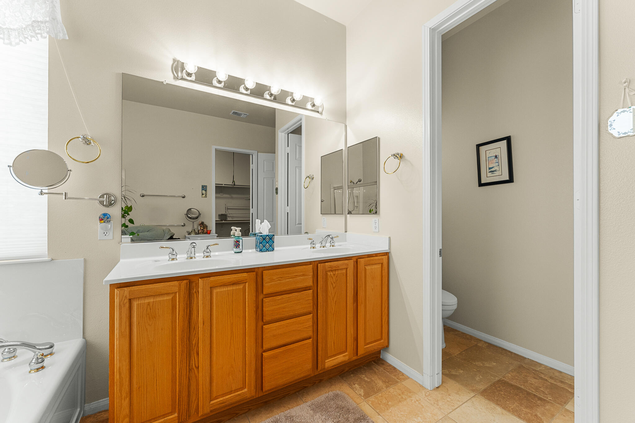 744 Copper Circle Beaumont, CA 92223 - Photo 25 of 44 a bathroom with a granite countertop sink a mirror and a
