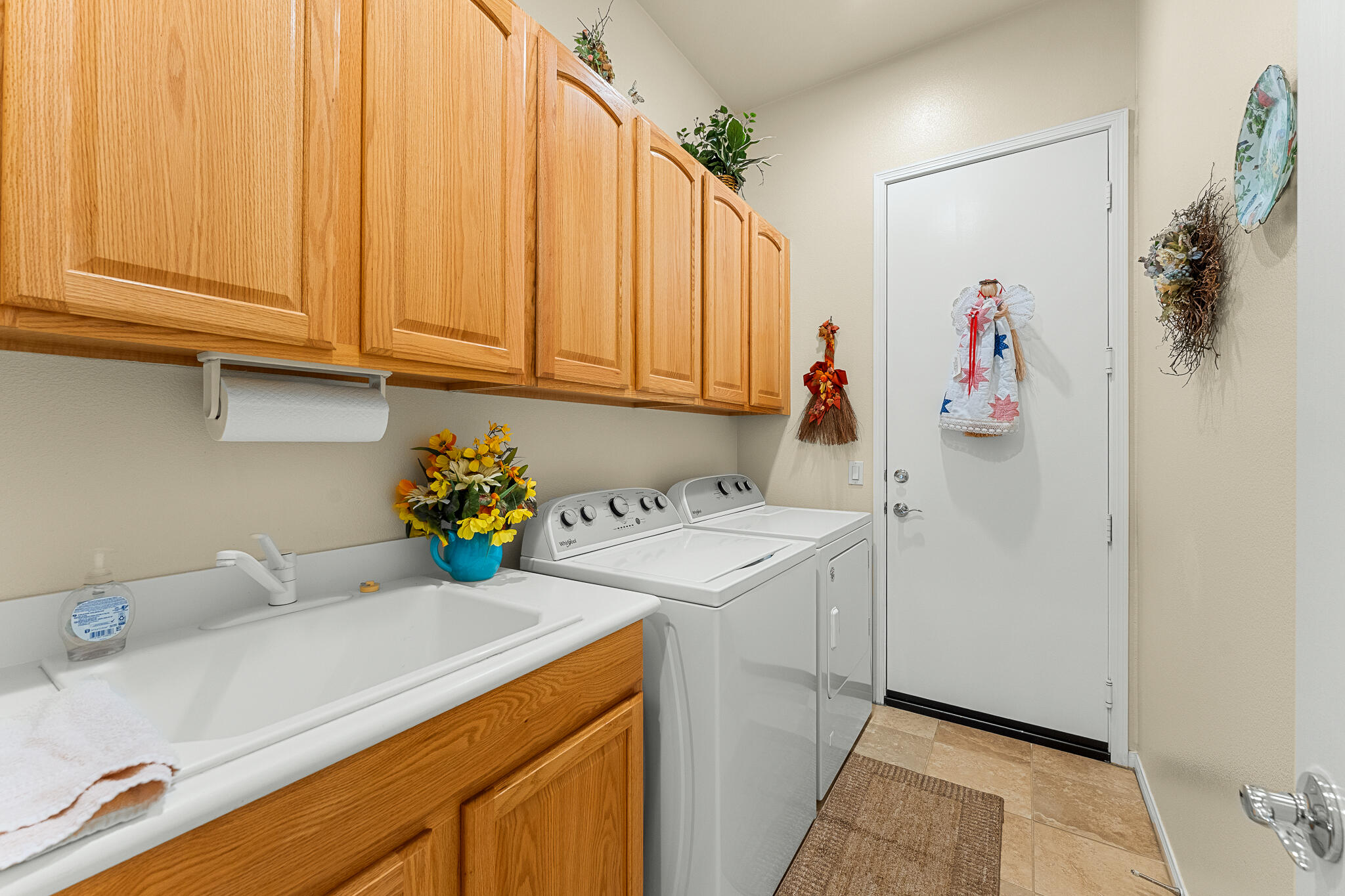 744 Copper Circle Beaumont, CA 92223 - Photo 27 of 44 a utility room with a sink a cabinetry and appliances