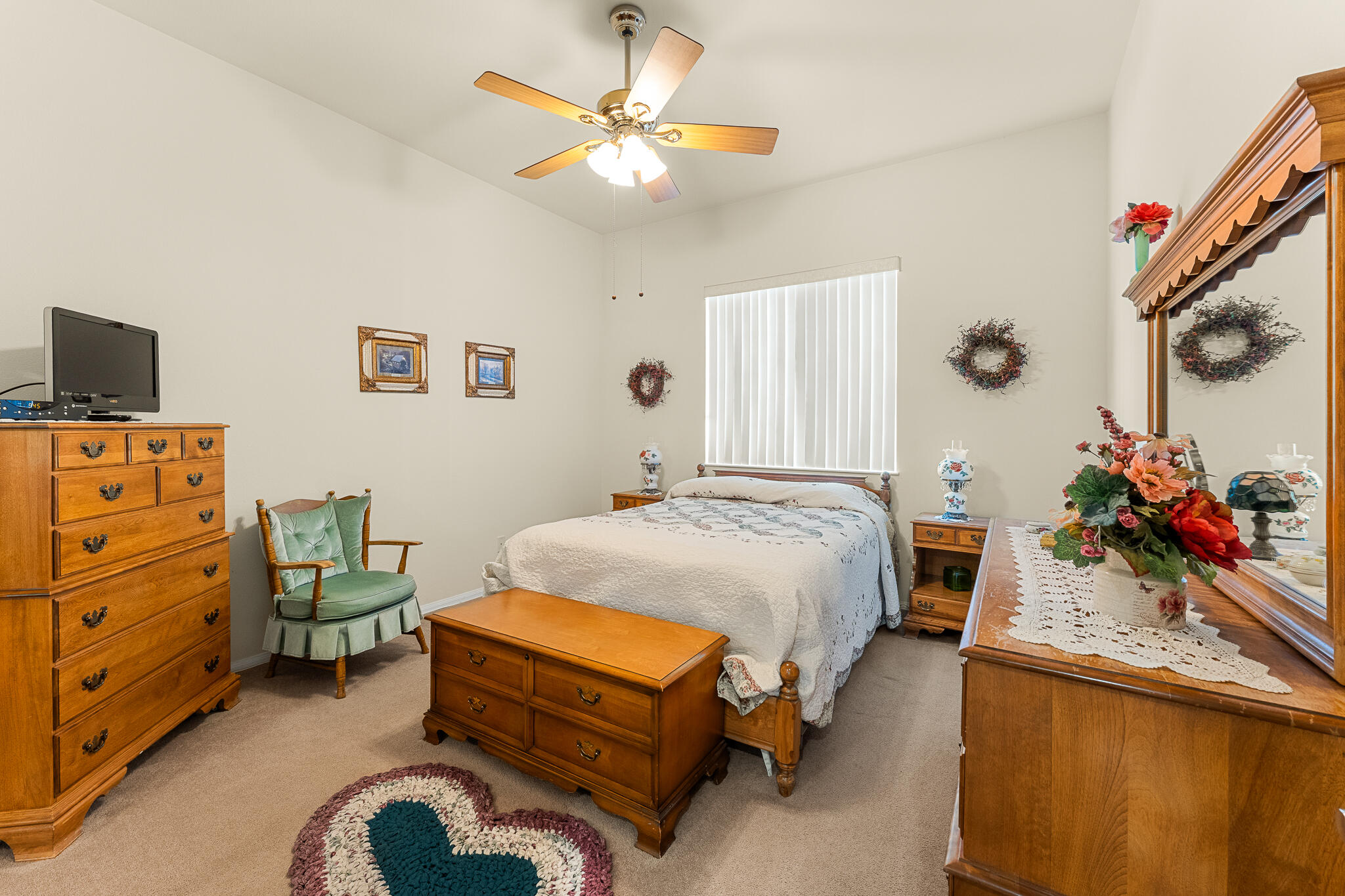 744 Copper Circle Beaumont, CA 92223 - Photo 28 of 44 a bedroom with a bed and a chandelier