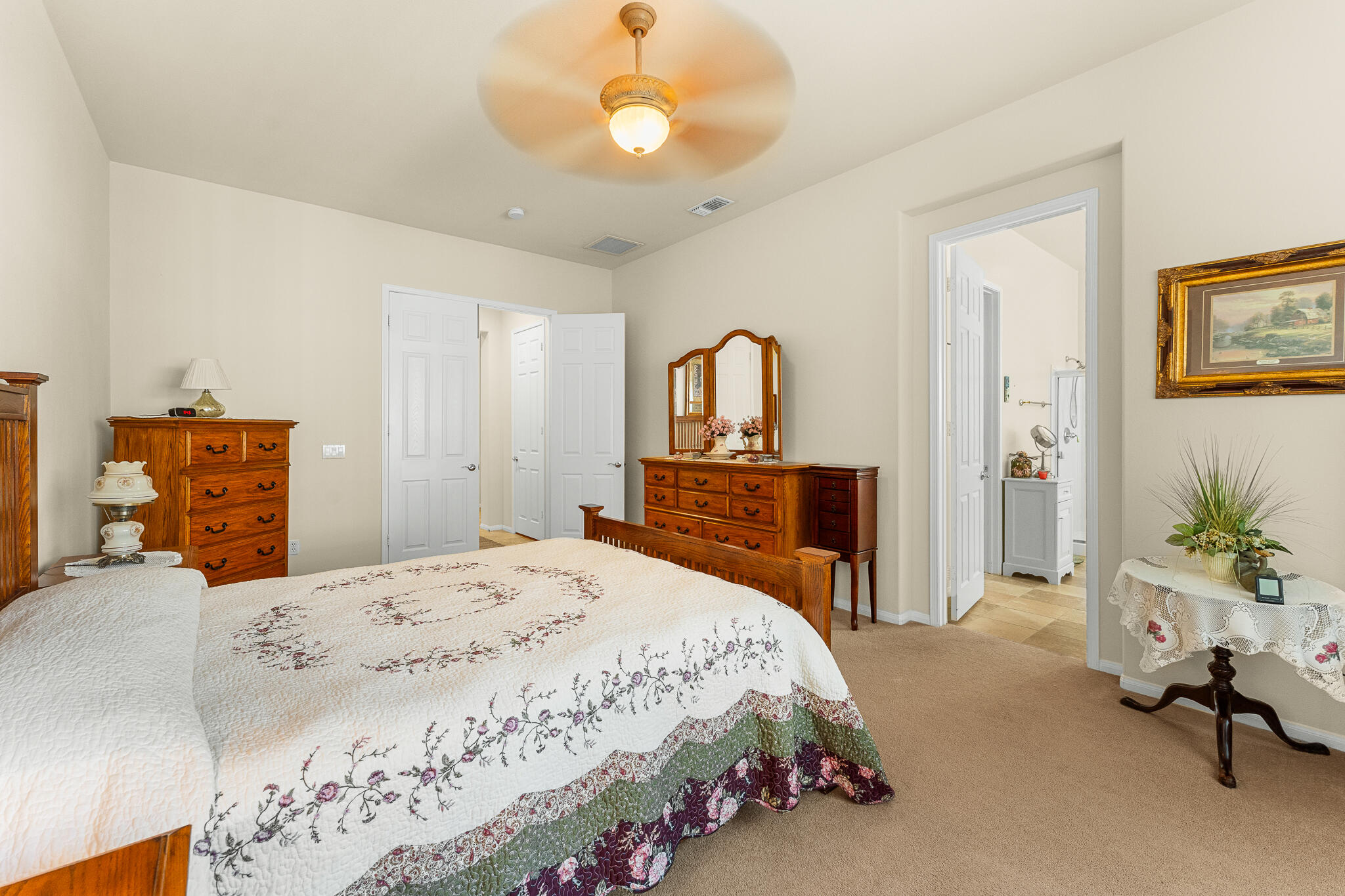 744 Copper Circle Beaumont, CA 92223 - Photo 29 of 44 a bedroom with a bed and a chandelier