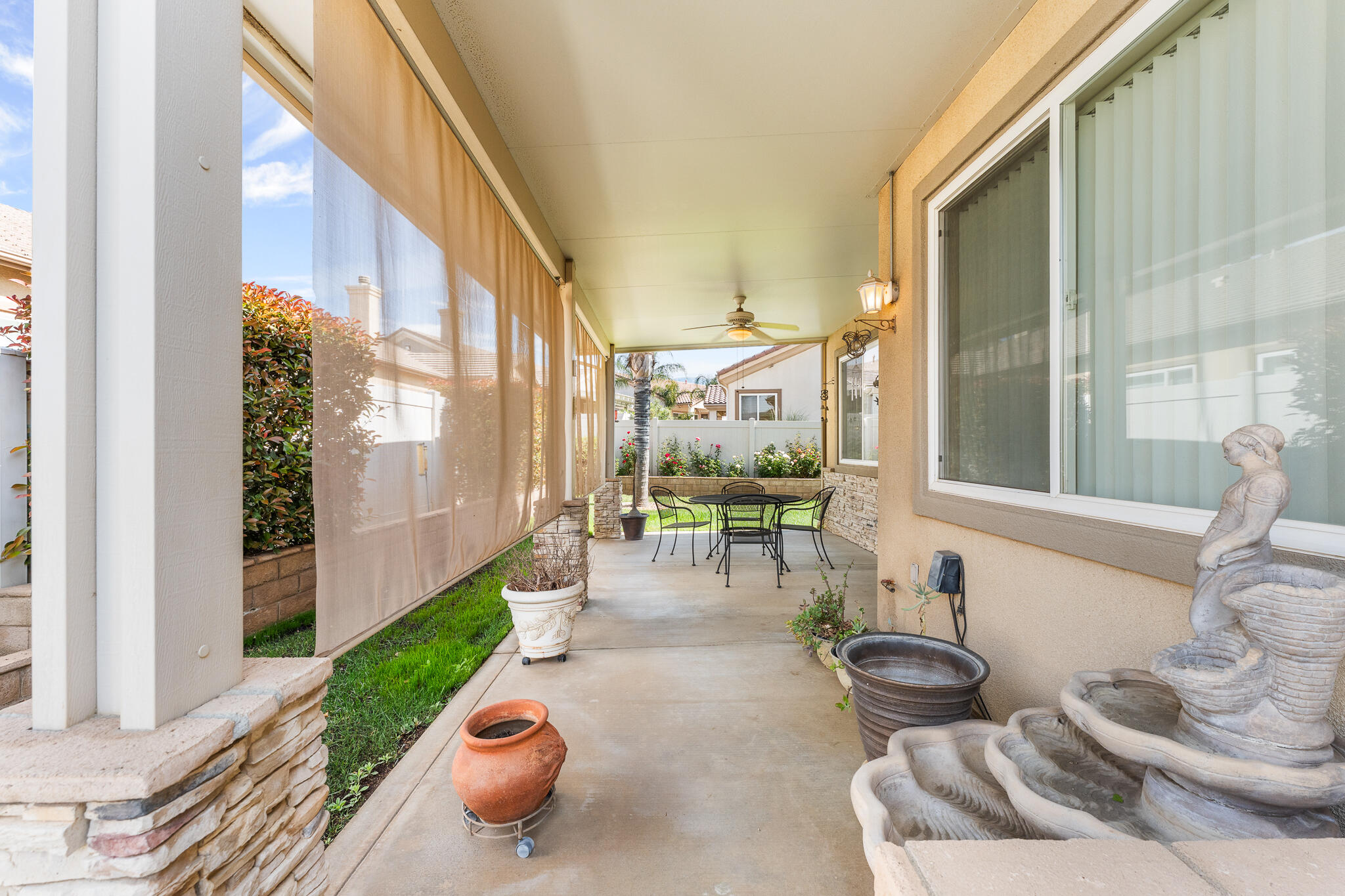 744 Copper Circle Beaumont, CA 92223 - Photo 36 of 44 a view of a patio with couple of chairs and a potted plant