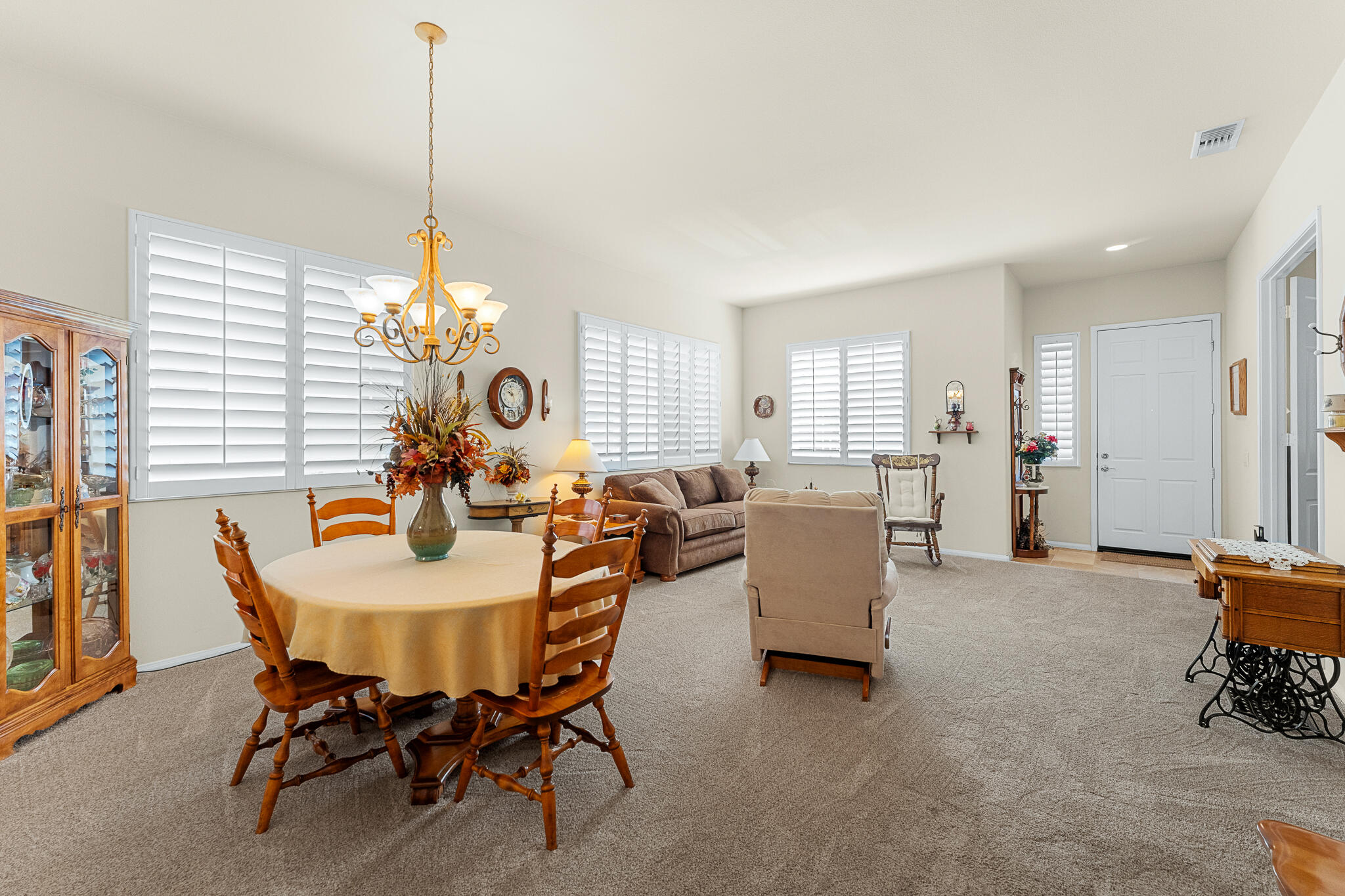 744 Copper Circle Beaumont, CA 92223 - Photo 10 of 44 a view of a dining room and livingroom with furniture wooden floor a chandelier