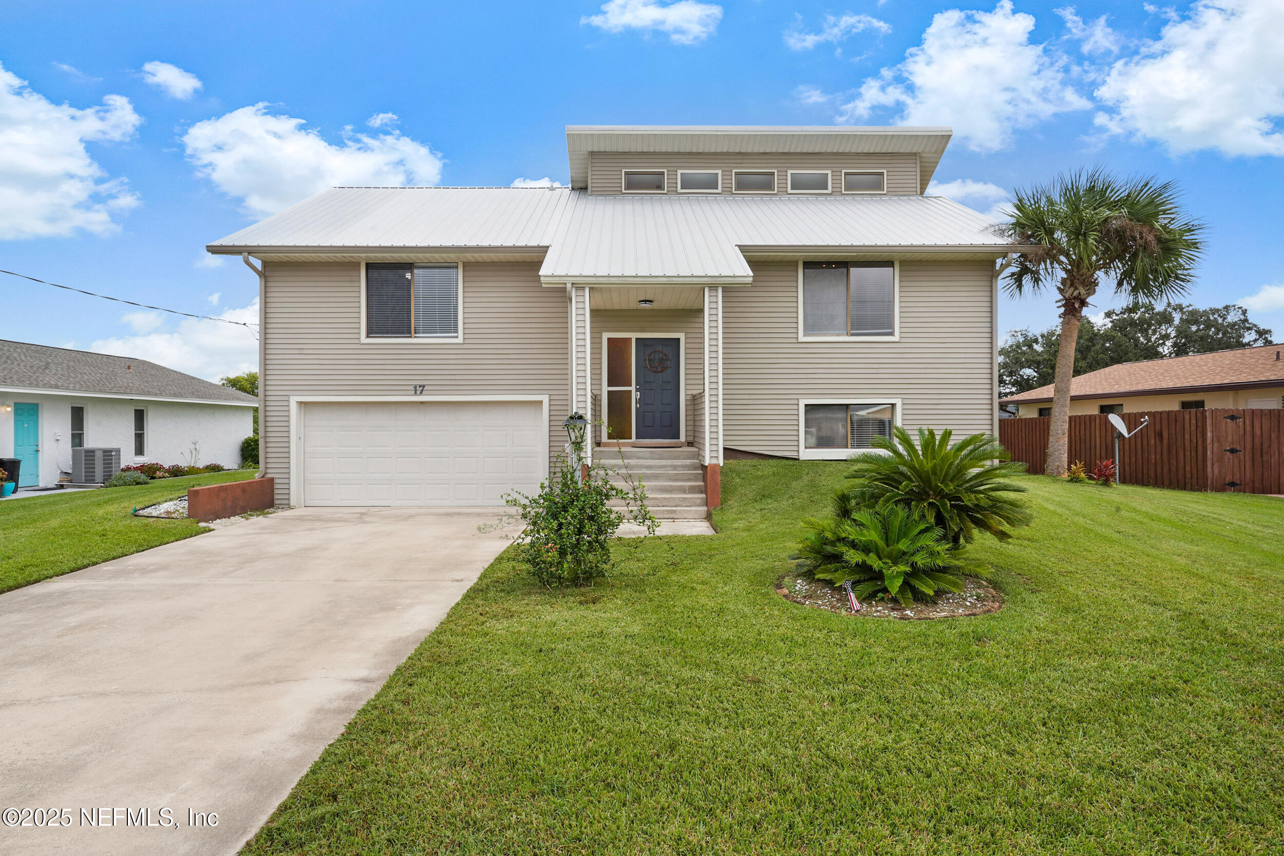 17 Clinton Court South Palm Coast, FL 32137 - Photo 1 of 44 a front view of a house with a garden