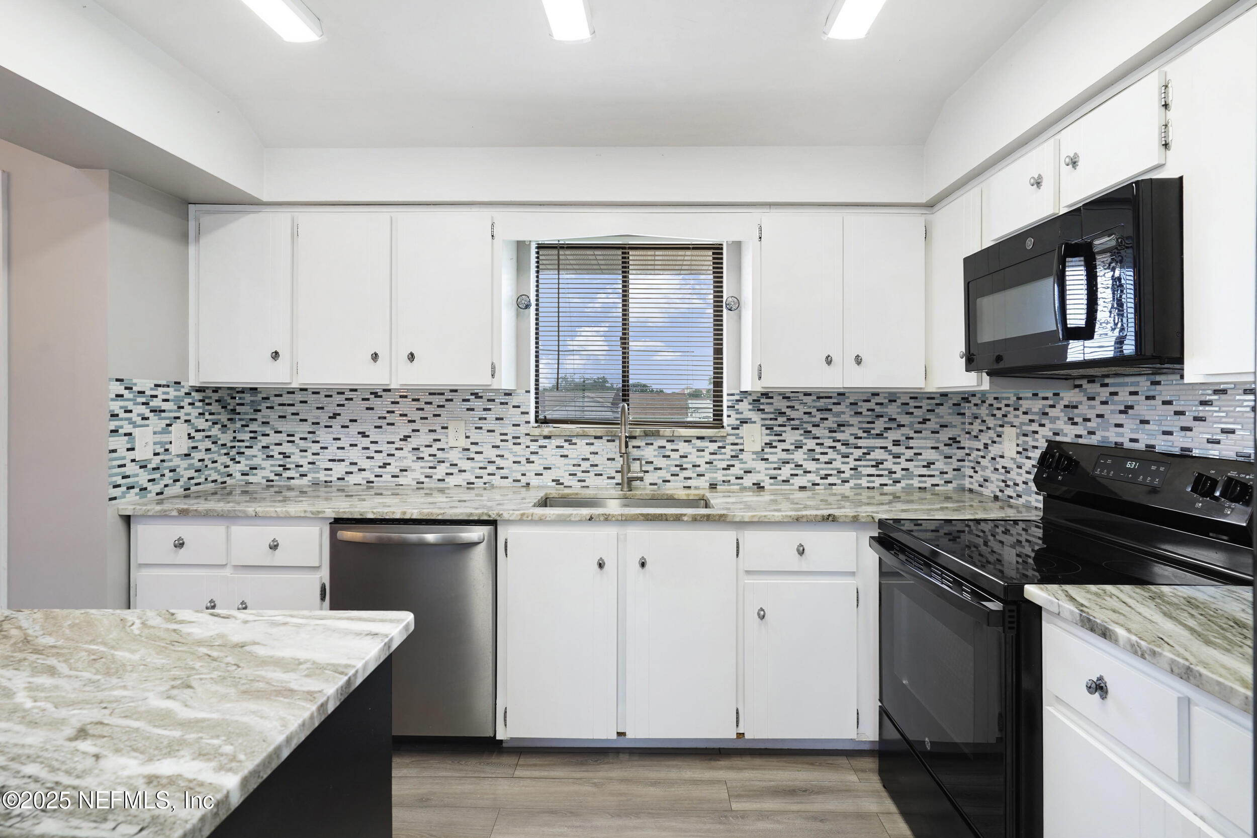 17 Clinton Court South Palm Coast, FL 32137 - Photo 11 of 44 a kitchen with granite countertop cabinets stove top oven and sink