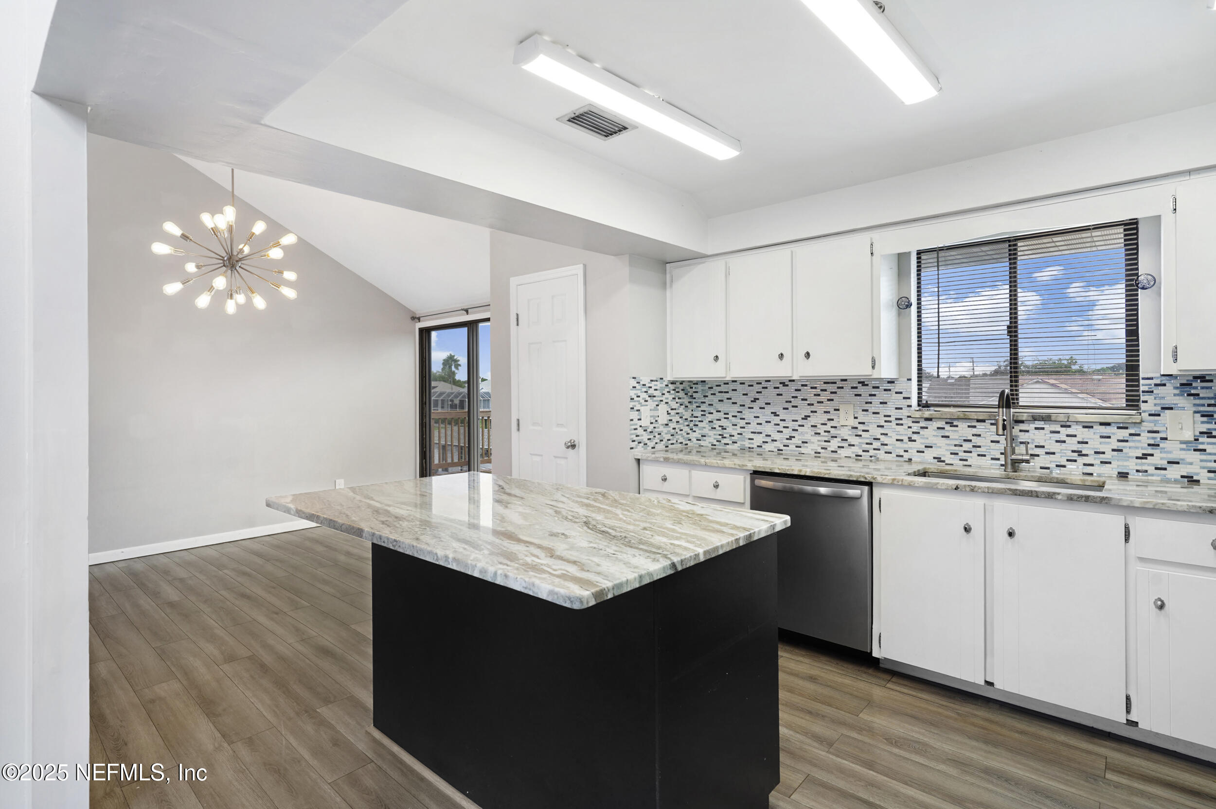 17 Clinton Court South Palm Coast, FL 32137 - Photo 12 of 44 a kitchen with granite countertop cabinets a sink dishwasher and a stove with wooden floor