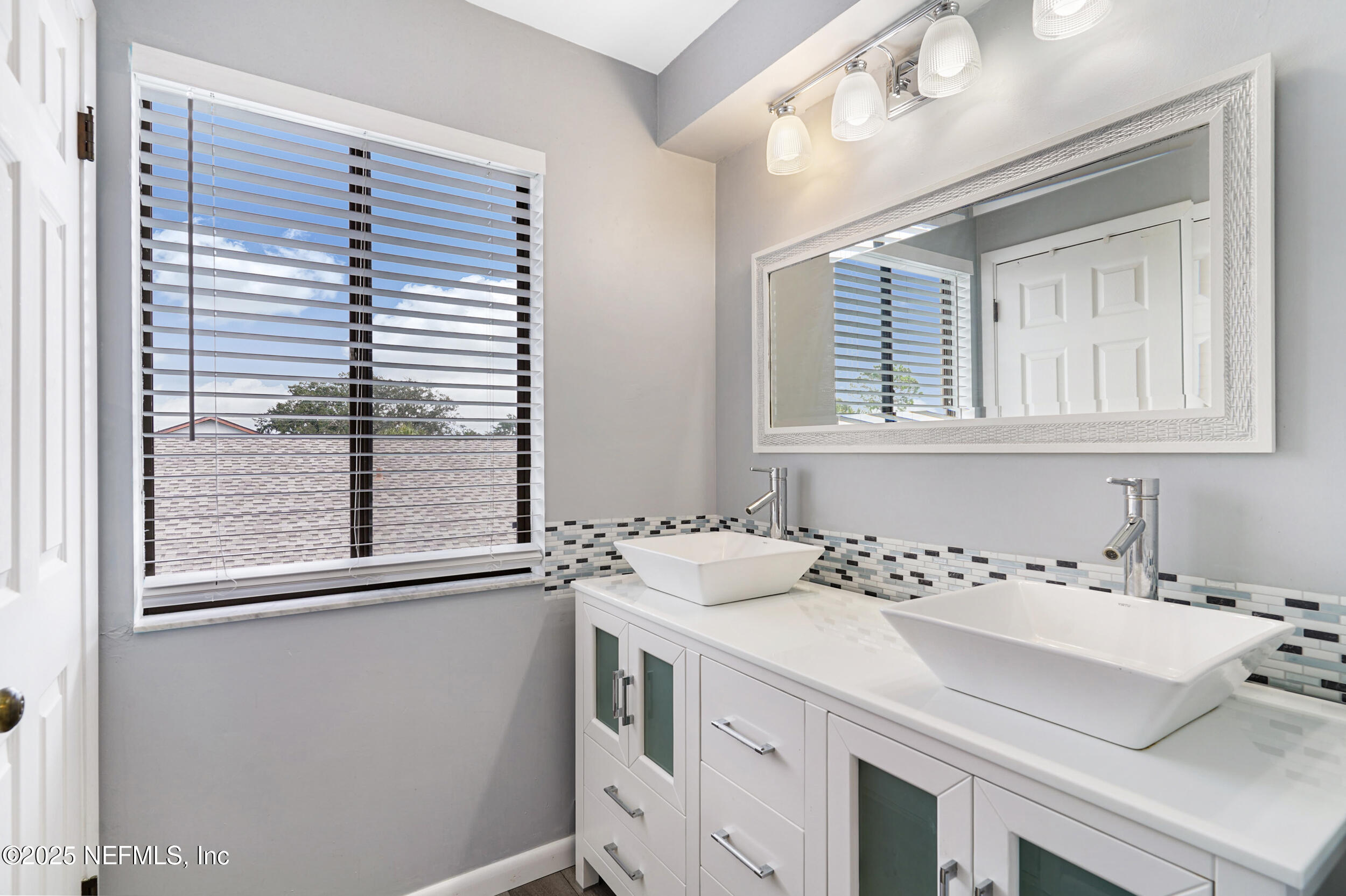 17 Clinton Court South Palm Coast, FL 32137 - Photo 24 of 44 a bathroom with a sink and a window