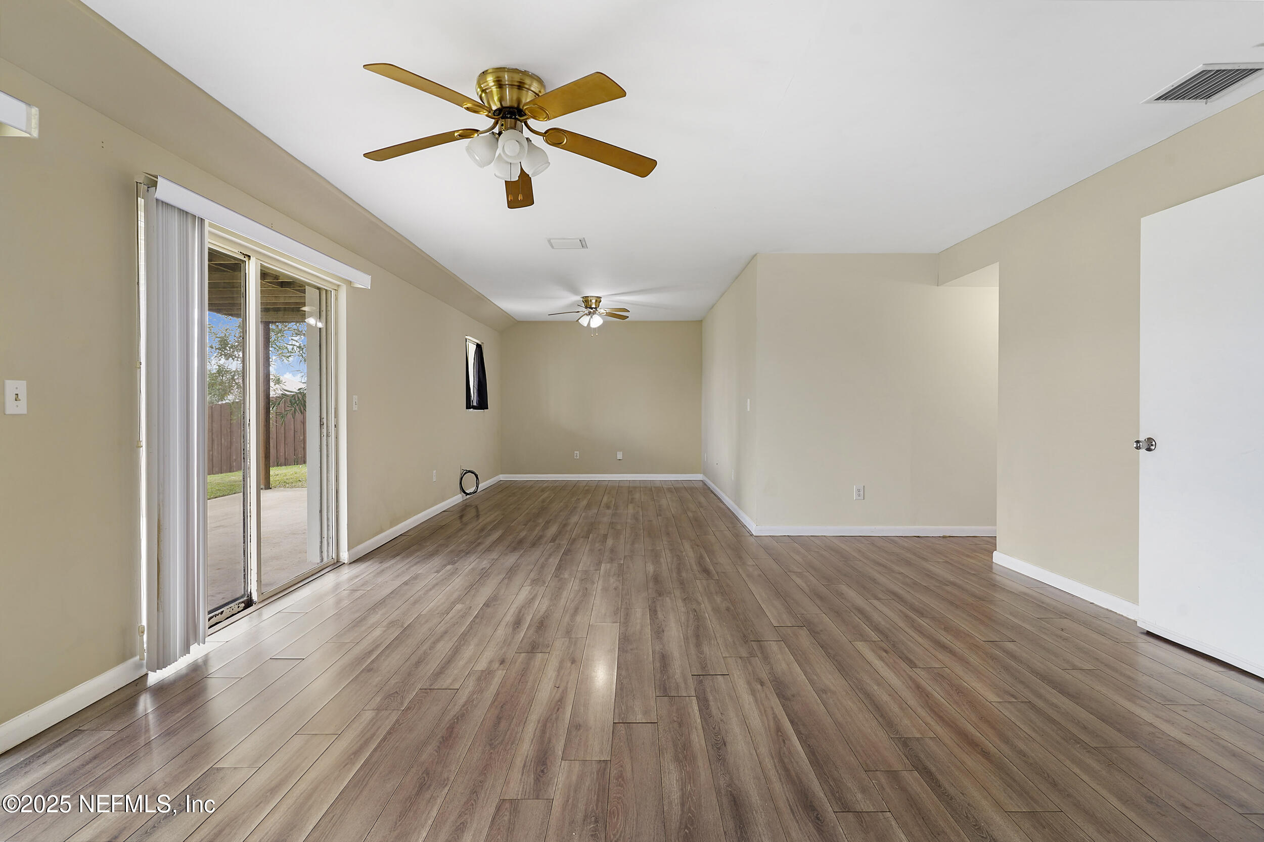 17 Clinton Court South Palm Coast, FL 32137 - Photo 29 of 44 an empty room with wooden floor and windows