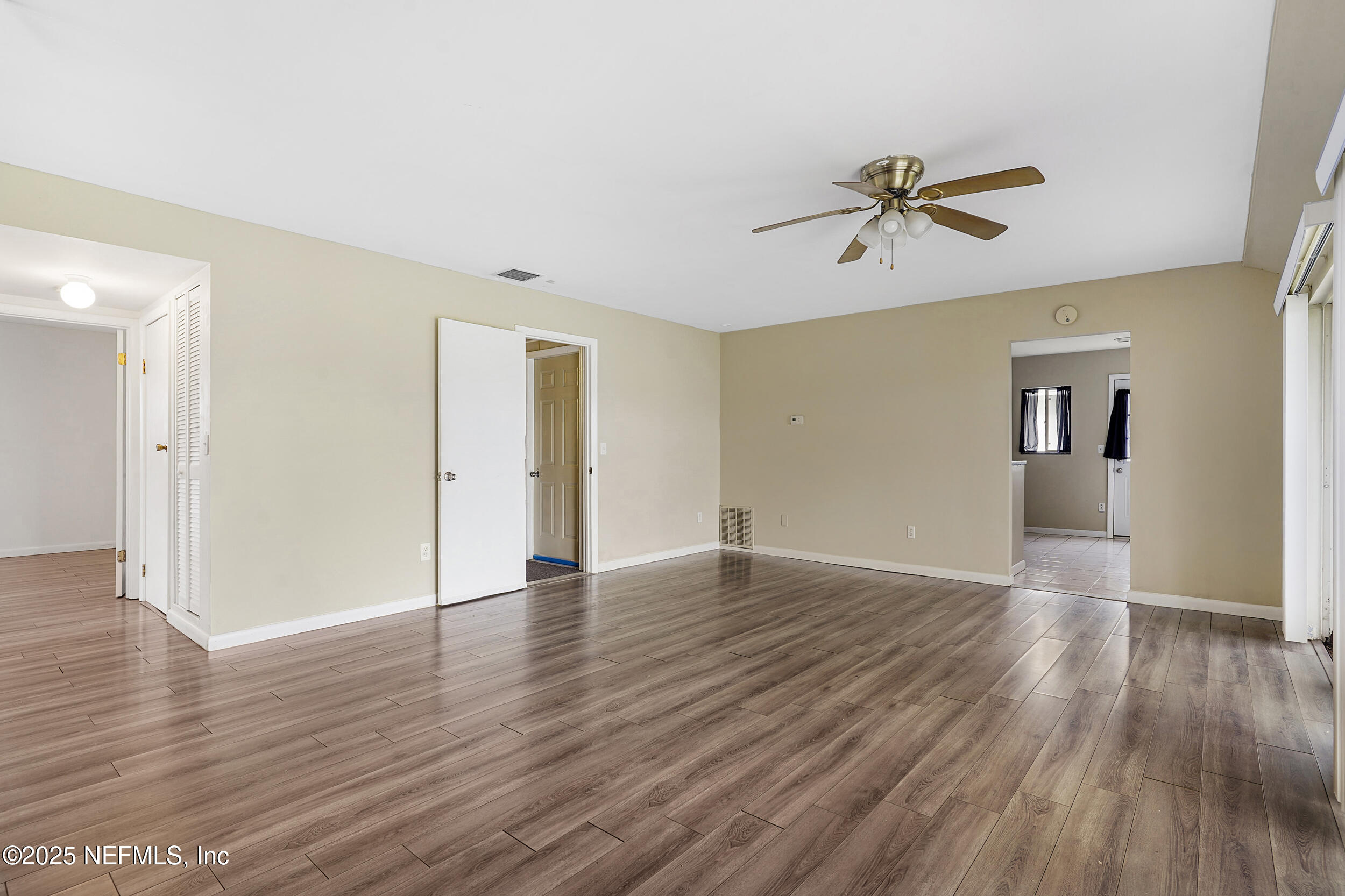 17 Clinton Court South Palm Coast, FL 32137 - Photo 30 of 44 an empty room with wooden floor and windows