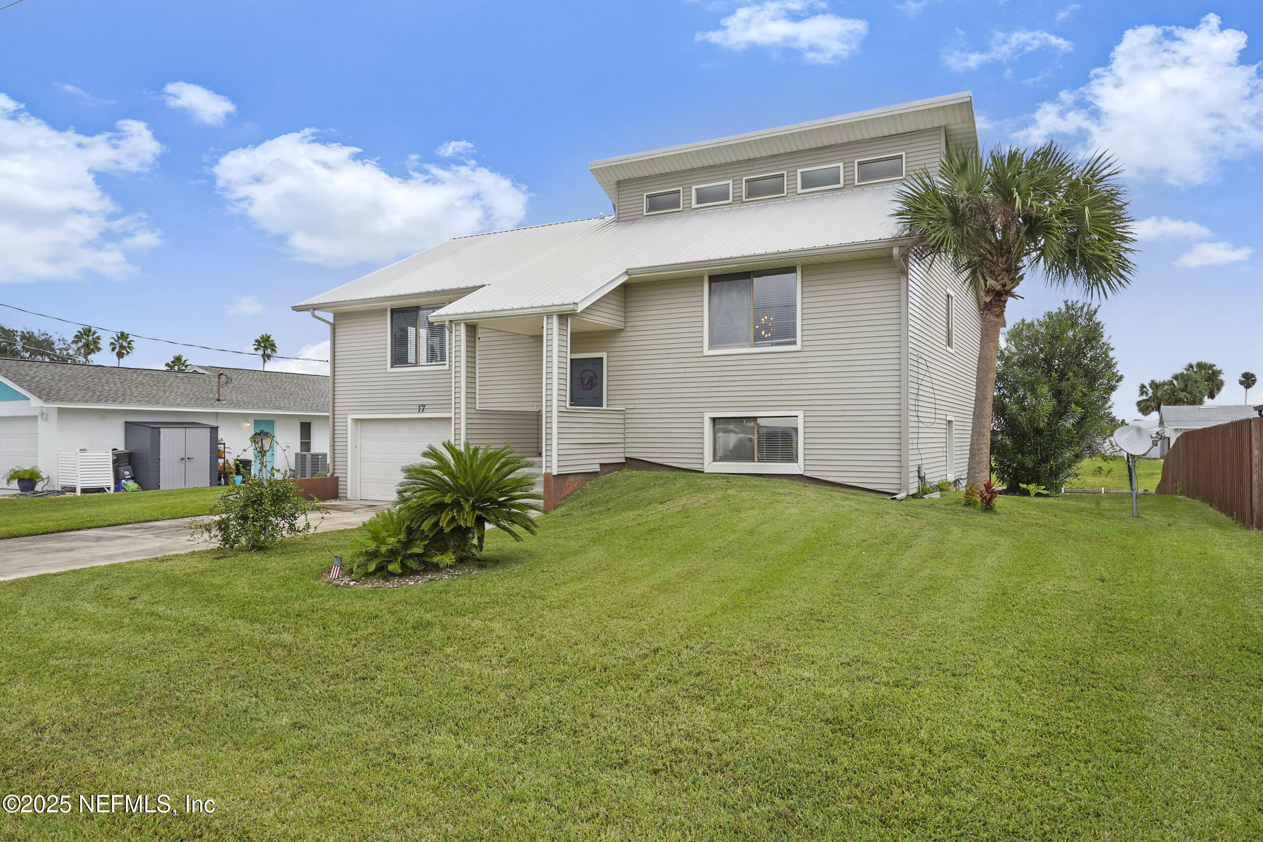 17 Clinton Court South Palm Coast, FL 32137 - Photo 3 of 44 a front view of house with yard and outdoor seating