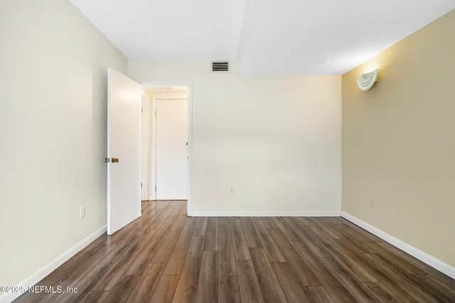 a view of a room with wooden floor