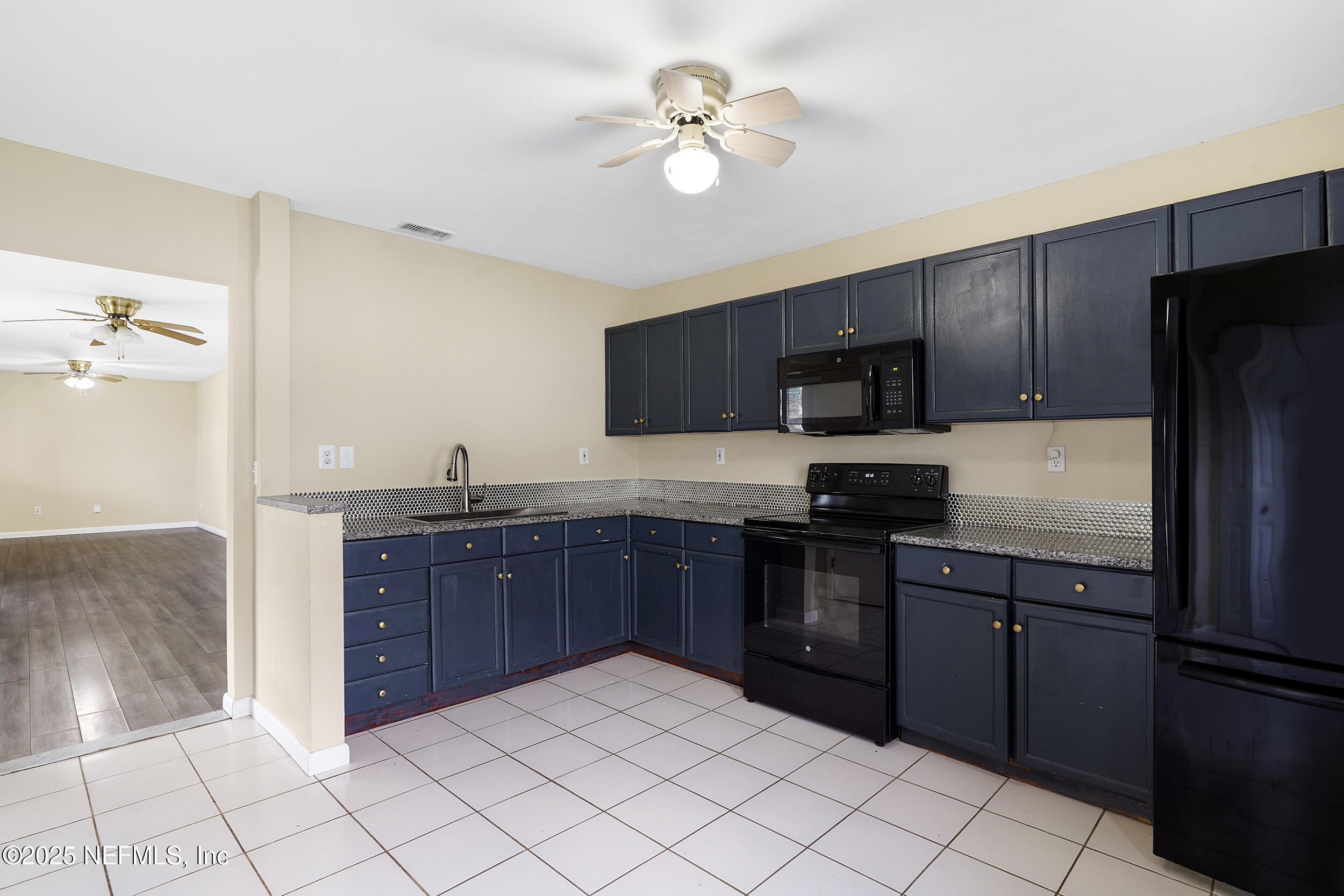 17 Clinton Court South Palm Coast, FL 32137 - Photo 37 of 44 a kitchen with stainless steel appliances granite countertop a refrigerator and a sink