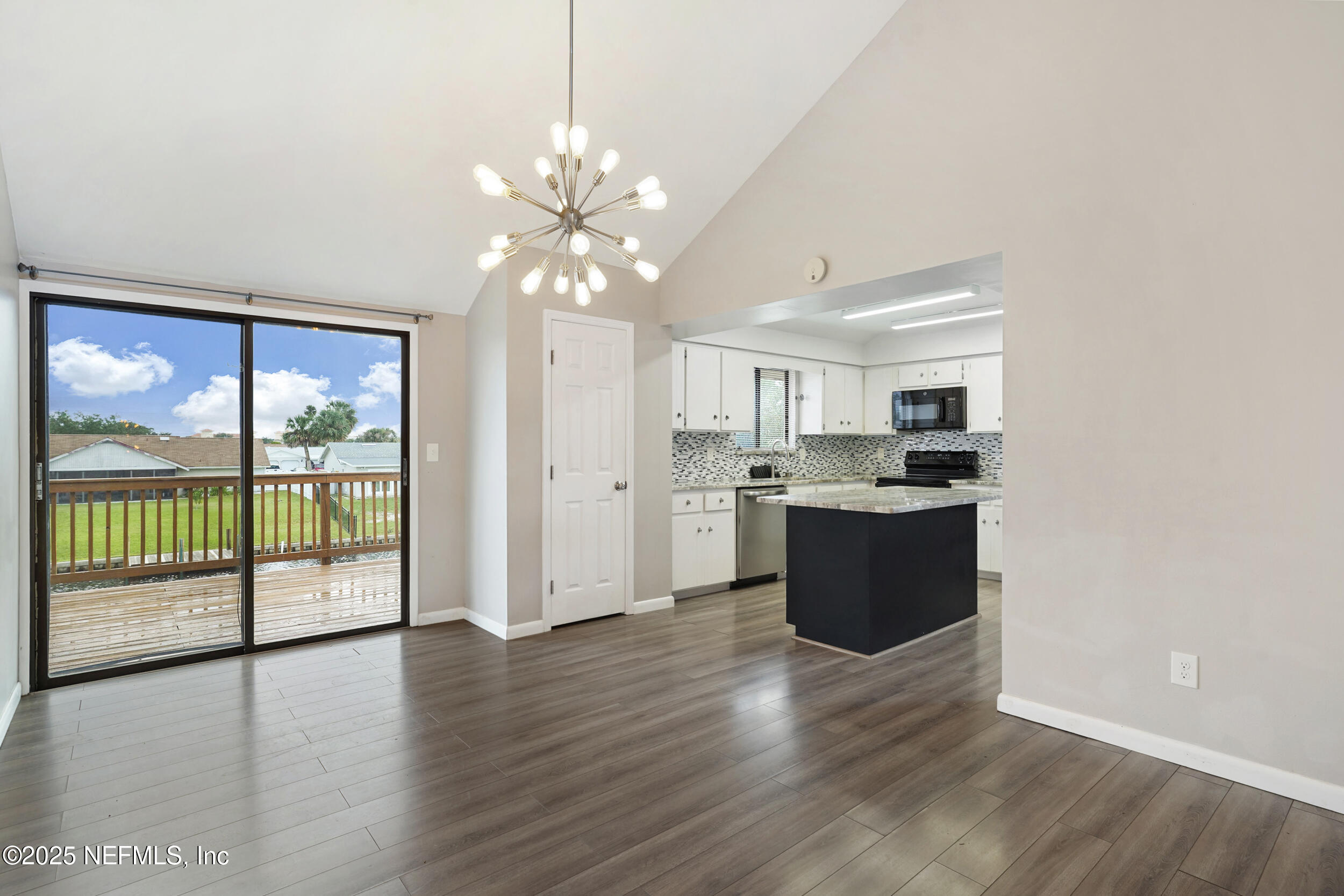 17 Clinton Court South Palm Coast, FL 32137 - Photo 6 of 44 a large kitchen with hardwood floor and a large window
