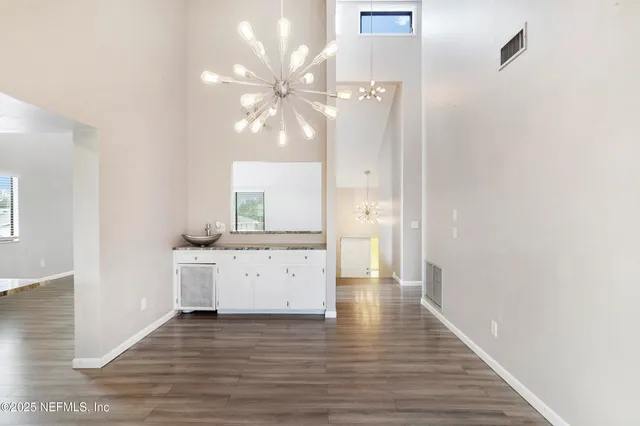 a view of a kitchen with a sink and wooden floor