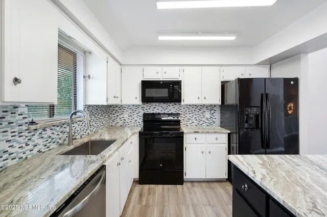 a kitchen with a sink stove and refrigerator