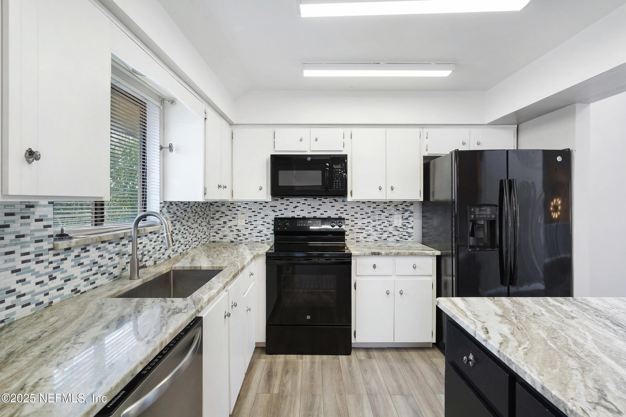 17 Clinton Court South Palm Coast, FL 32137 - Photo 10 of 44 a kitchen with a sink stove and refrigerator