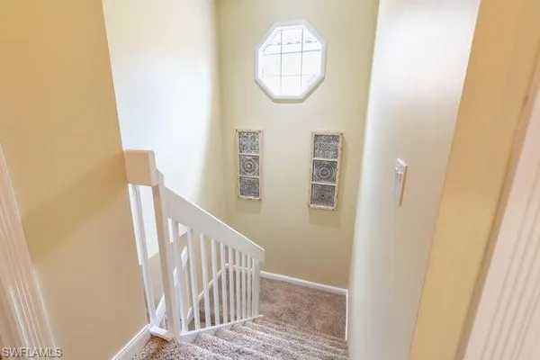a view of a hallway with wooden floor and entryway