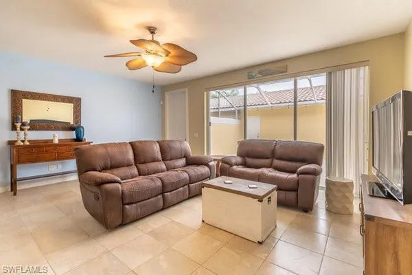 a living room with furniture and a large window