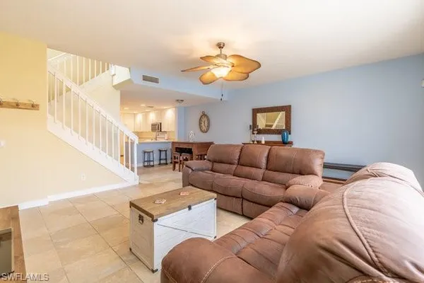 a living room with furniture and a chandelier
