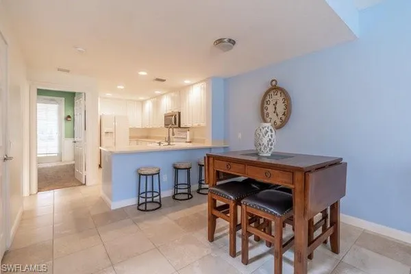 a view of kitchen with cabinets and window