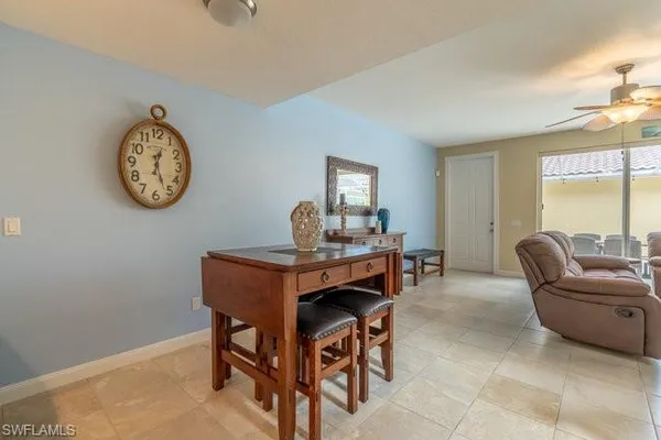a living room with furniture a window and a clock