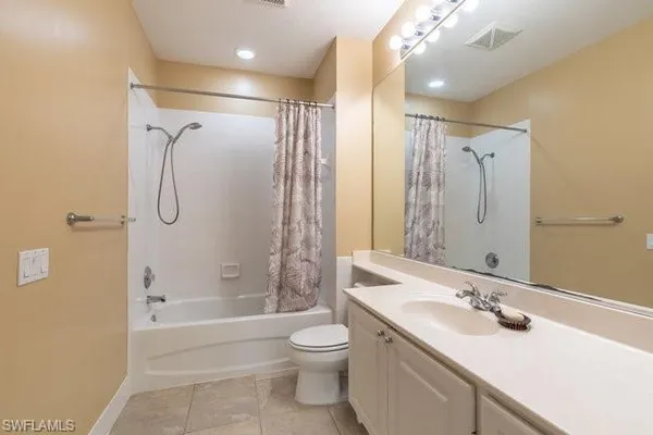 a bathroom with a double vanity sink toilet mirror and shower