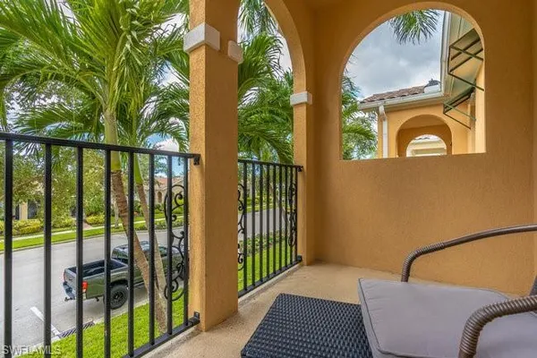 a view of a balcony with iron fence